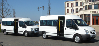 14-seater Ford Transit schoolbuses from JOYRIDE in front of the congress center Hohe Duene in Rostock - Warnemuende